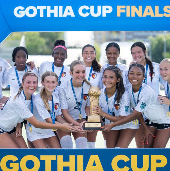 Group of female athletes celebrating with a trophy at the Gothia Cup Finals.
